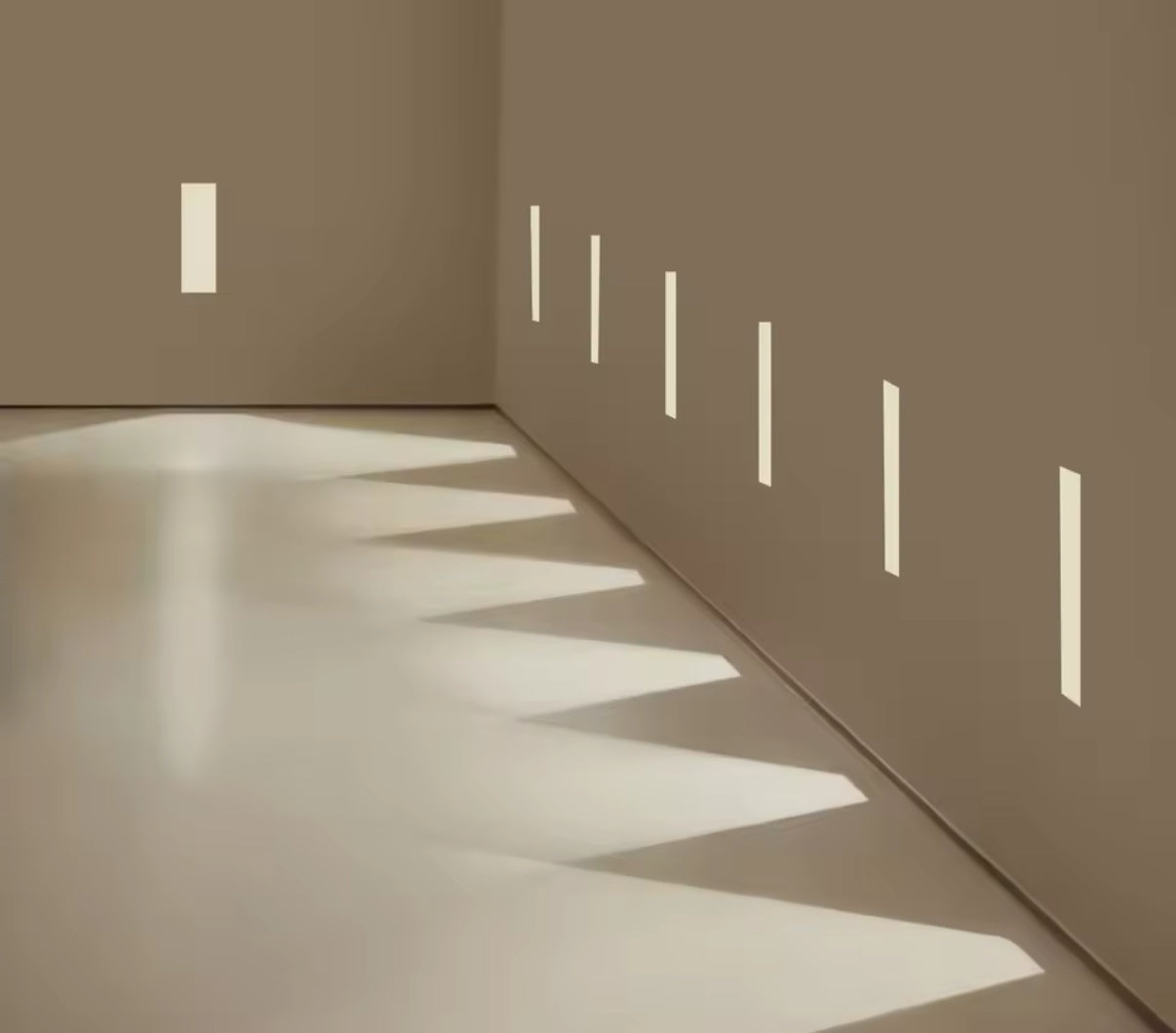 Installation de plusieurs signaleurs LED encastrés créant des faisceaux lumineux géométriques – éclairage architectural moderne