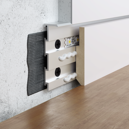 Profilé de plinthe invisible S1060 en aluminium avec fixation murale, rail LED intégré et système d’installation affleurante pour cloison.