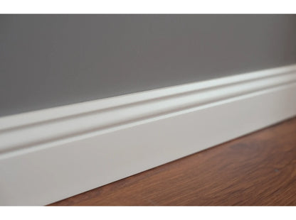 Détail de la plinthe MD094 – finition blanche et moulurée – pose contre mur gris – 200 x 9,4 x 1,2 cm